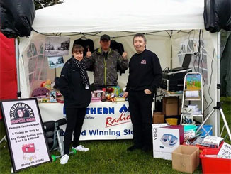 volunteers standing outside tent at prestwich carnival