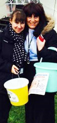 2 volunteers with fundraising buckets